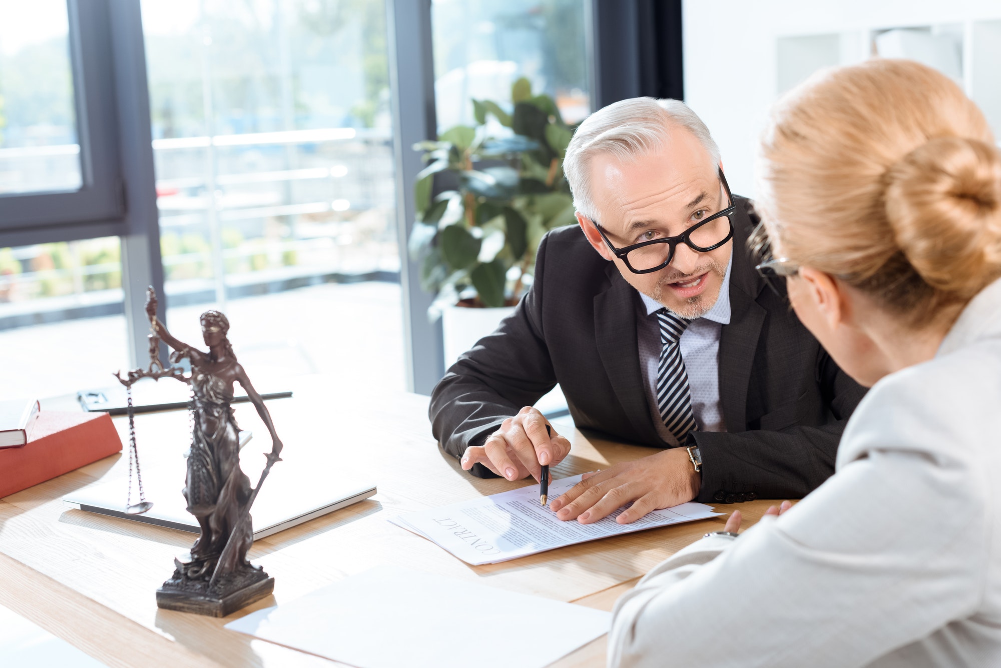 mature-serious-lawyers-discussing-business-documents-in-office.jpg
